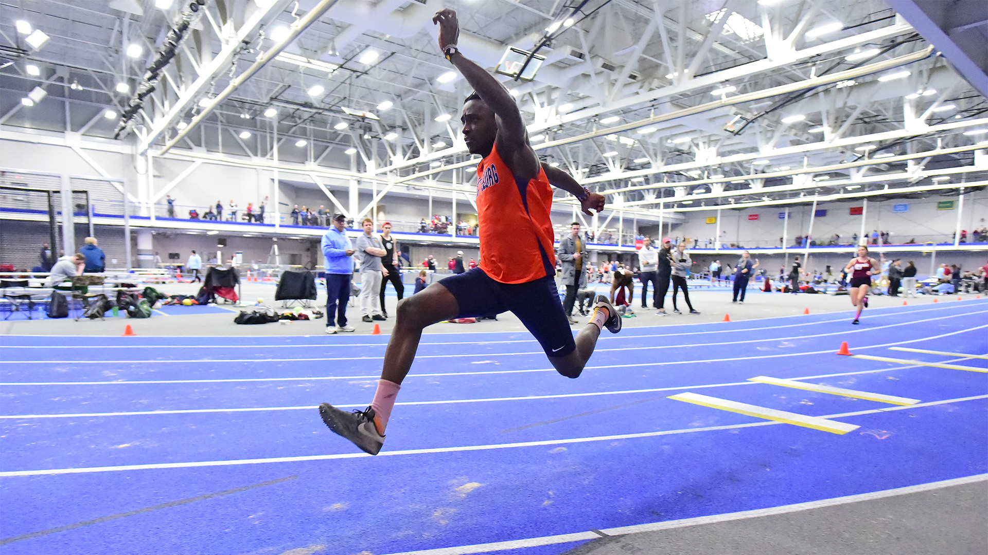 Fred Tubula is doing the triple jump at the Centennial Conference Indoor Track and Field Championships