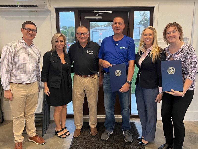Adams Electric Director Thomas J. Knaub stands with the life savers who came to his aid during a March heart attack.