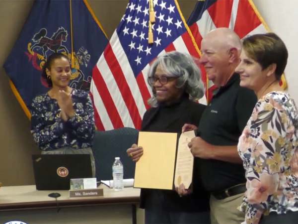 Gettysburg Borough Mayor Rita Frealing, left, congratulates retiring Police Sgt. Larry Weikert.