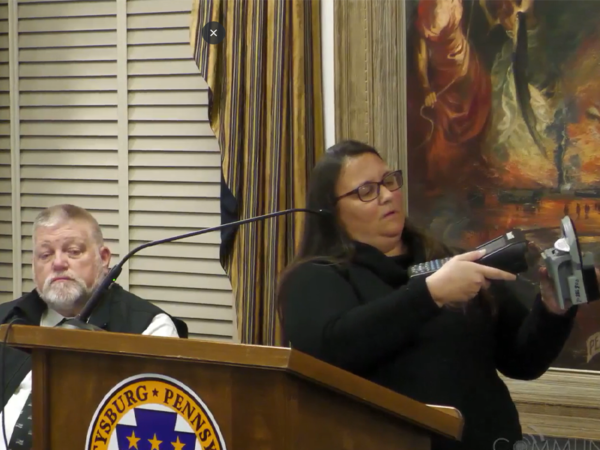 Gettysburg Borough Parking Manager Becka Fissel demonstrates how parking rates are adjusted as Borough Police Chief Robert Glenny looks on.