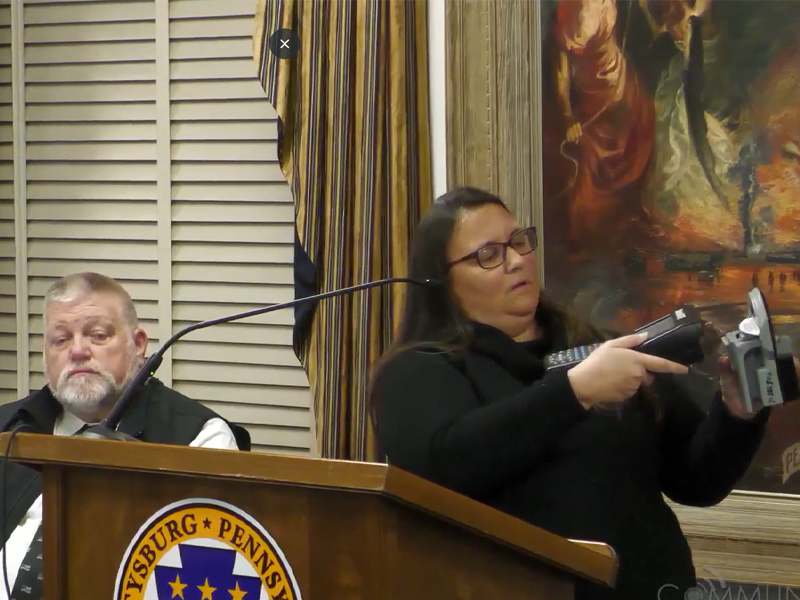Gettysburg Borough Parking Manager Becka Fissel demonstrates how parking rates are adjusted as Borough Police Chief Robert Glenny looks on.