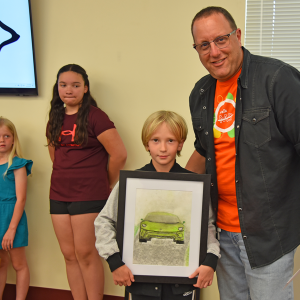 Gettysburg Area School District Assistant Superintendent Dr. Jeffrey Matzner presented the Superintendent Award to Franklin Township Elementary second grader Ellis Rice for his chalk pastels piece entitled "Lamborghini Time." (Photo Courtesy of GASD)