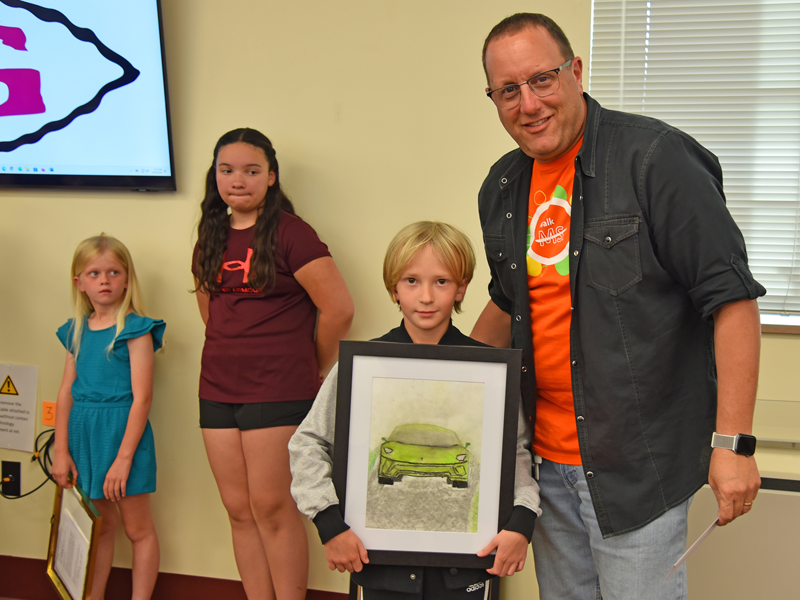 Gettysburg Area School District Assistant Superintendent Dr. Jeffrey Matzner presented the Superintendent Award to Franklin Township Elementary second grader Ellis Rice for his chalk pastels piece entitled "Lamborghini Time." (Photo Courtesy of GASD)