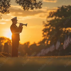 Solemn Military Bugler Playing Taps at Memorial Day Cemetery Ceremony with Flags Waving in Background