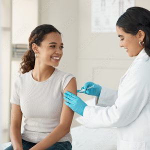 Injection, vaccine and patient at the clinic for consulting and help with prevention with a smile. Doctor, inject and woman on arm for virus with gloves in medical room for wellness or health.