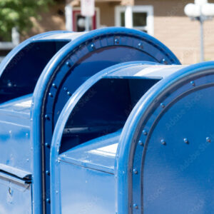 Two blue roadside mailboxes